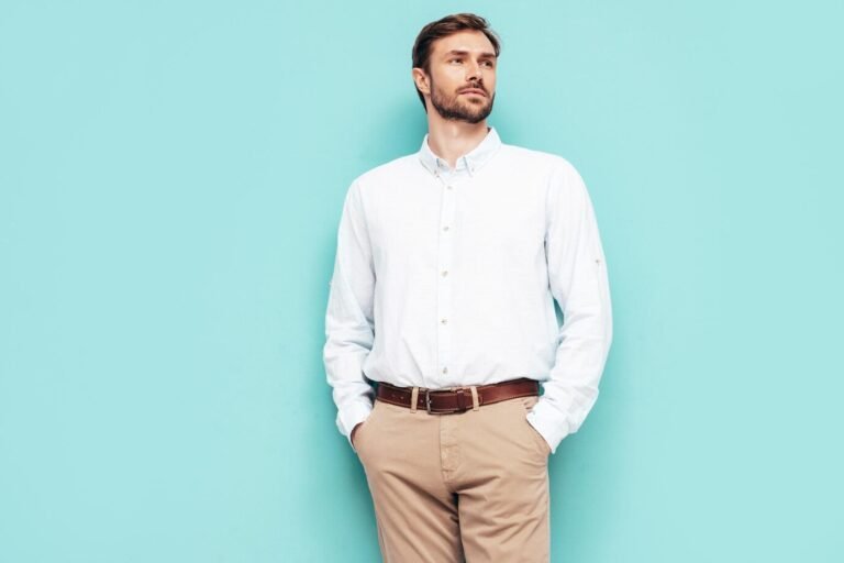 portrait-handsome-smiling-model-sexy-stylish-man-dressed-shirt-trousers-fashion-hipster-male-posing-near-blue-wall-studio-isolated_158538-26681